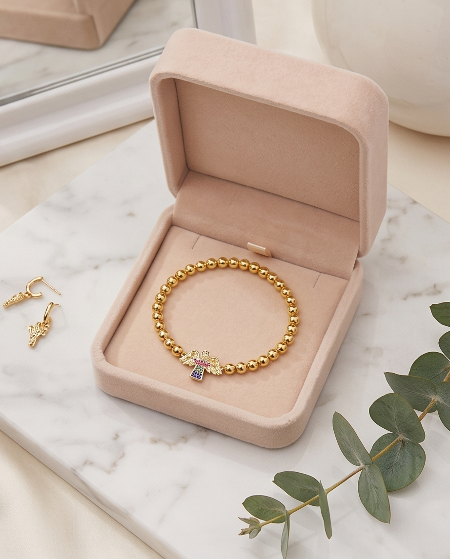 Gold bracelet in a pink jewelry box on a marble surface with green leaves. Heaven Sent by Stacked by Jayneebell