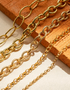 Gold chain necklace on a wooden surface